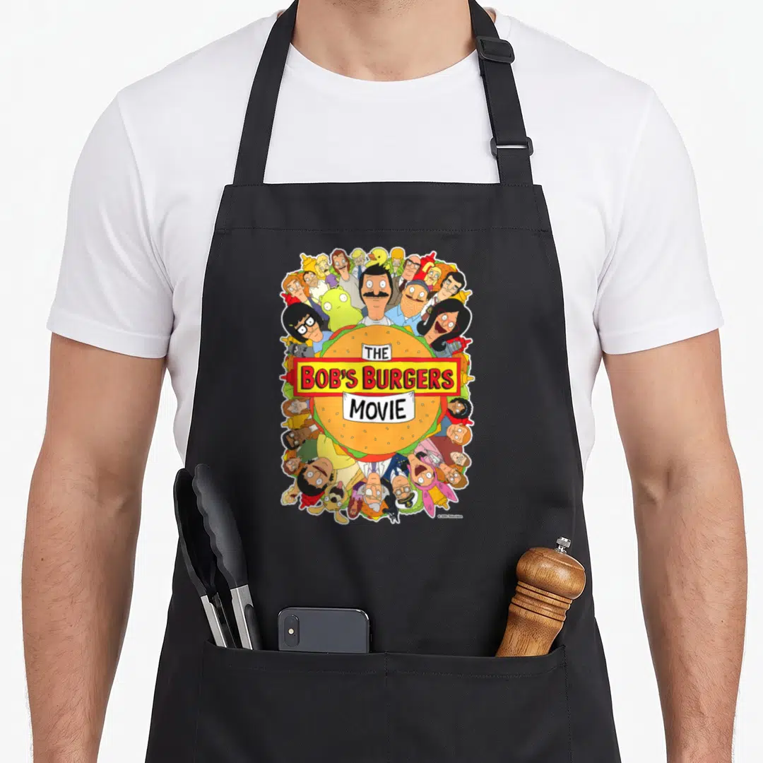 Poster bobs burger apron - Hamburger with THE BOB'S BURGERS MOVIE text surrounded by cartoon characters in orange — shown on a black cotton canvas apron against a white background