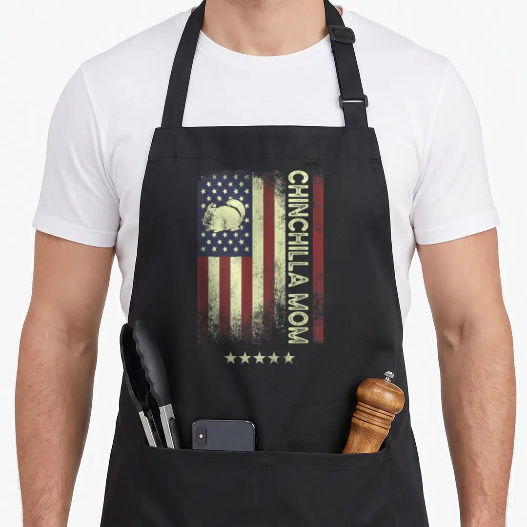 Chinchilla american flag apron - Distressed flag with chinchilla silhouette and vertical CHINCHILLA MOM text in red — shown on a black cotton canvas apron against a white background