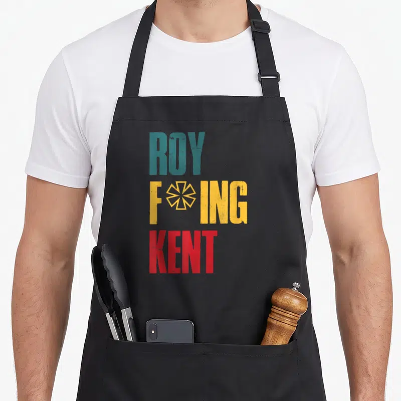 Freaking rob roy apron - Stacked ROY FOING KENT text in teal yellow red with geometric star symbol — shown on a black cotton canvas apron against a white background