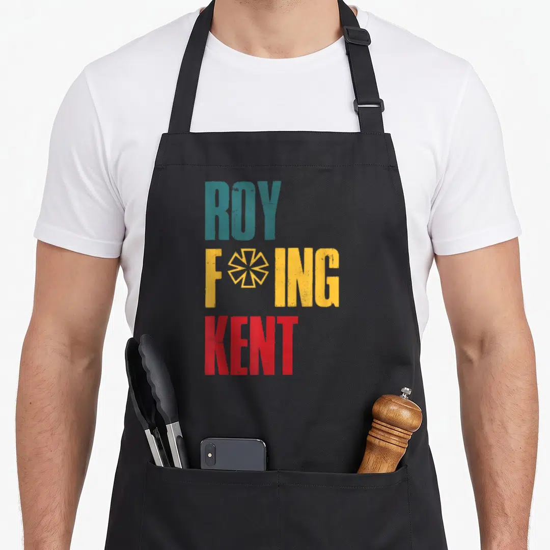 Freaking rob roy apron - Stacked ROY FOING KENT text in teal yellow red with geometric star symbol — shown on a black cotton canvas apron against a white background