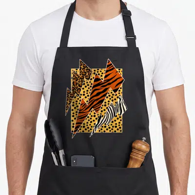 Leopard zebra apron - Retro lightning bolts with leopard tiger zebra prints on yellow polka dot background — shown on a black cotton canvas apron against a white background