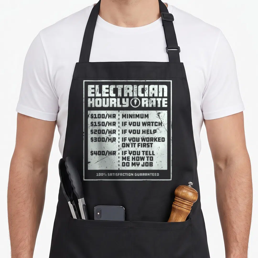 Hourly rate electricians apron - Distressed white price list with hourly rates for electrician supervision and advice — shown on a black cotton canvas apron against a white background