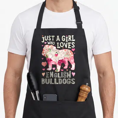 Flower english chef aprons - Floral bulldog silhouette with hearts and text Just A Girl Who Loves English Bulldogs — shown on a black cotton canvas apron against a white background