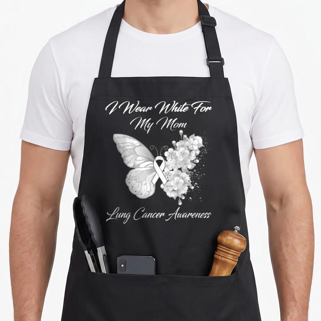 Lung butterfly apron - Grey and white butterfly with floral wing and ribbon, text I Wear White For My Mom — shown on a black cotton canvas apron against a white background