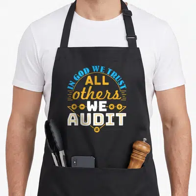 Auditor accountant apron - Stacked IN GOD WE TRUST ALL OTHERS WE AUDIT text with math symbols in yellow and blue — shown on a black cotton canvas apron against a white background