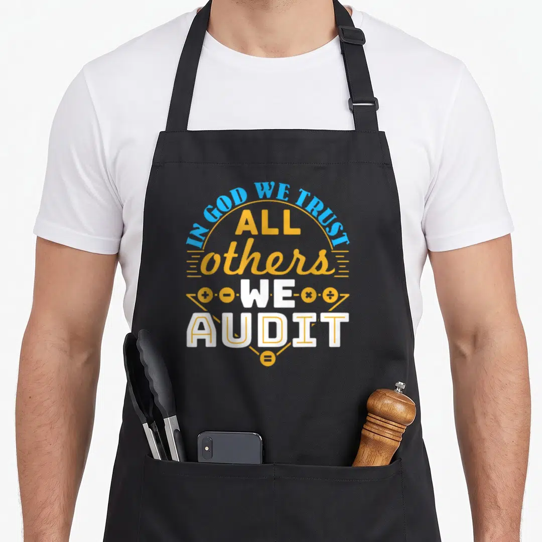 Auditor accountant apron - Stacked IN GOD WE TRUST ALL OTHERS WE AUDIT text with math symbols in yellow and blue — shown on a black cotton canvas apron against a white background