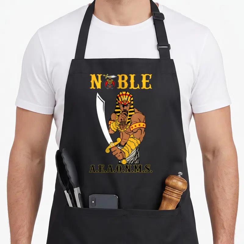 Pharaoh mason apron - Cartoon pharaoh holding sword with NOBLE and AEAONMS text in yellow and black — shown on a black cotton canvas apron against a white background