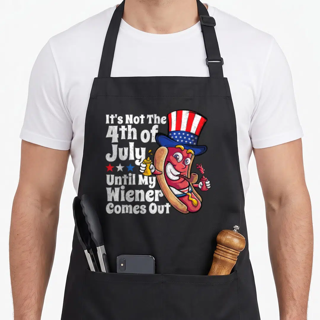 4th hot dog apron - Cartoon hot dog in patriotic hat holding mustard and ketchup next to stacked white text — shown on a black cotton canvas apron against a white background