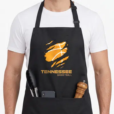 Fan volunteer apron - Orange basketball behind black claw marks with Tennessee Basketball text below — shown on a black cotton canvas apron against a white background