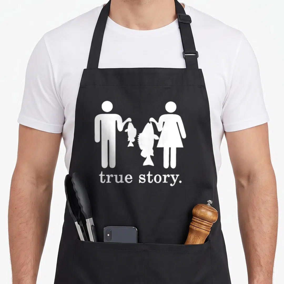 Story fishing fish apron - White stick figures holding fish of different sizes with text true story below — shown on a black cotton canvas apron against a white background