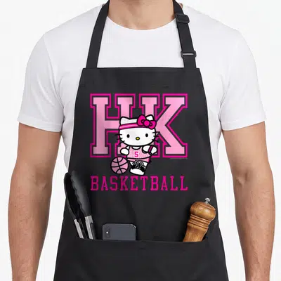 Basketball hello apron - Hello Kitty in pink jersey with HK letters and basketball text — shown on a black cotton canvas apron against a white background