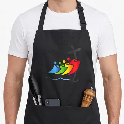 Jubilee catholic apron - Four colorful stylized figures over black cross and anchor with Iubilaeum A.D. MMXXV text — shown on a black cotton canvas apron against a white background