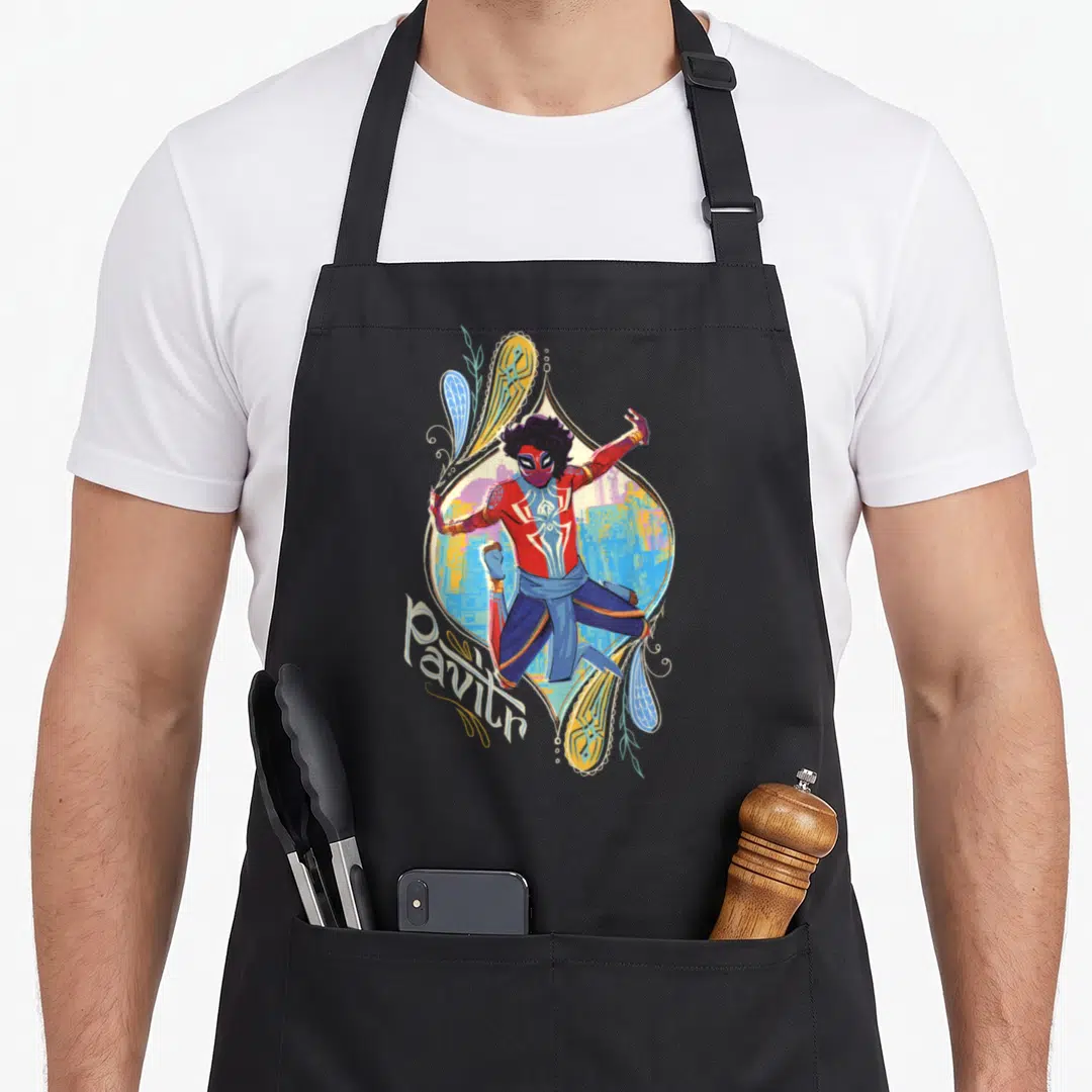Pavitr parts of an apron - Spider-Man in red and blue suit inside paisley frame with Pavitr script text — shown on a black cotton canvas apron against a white background