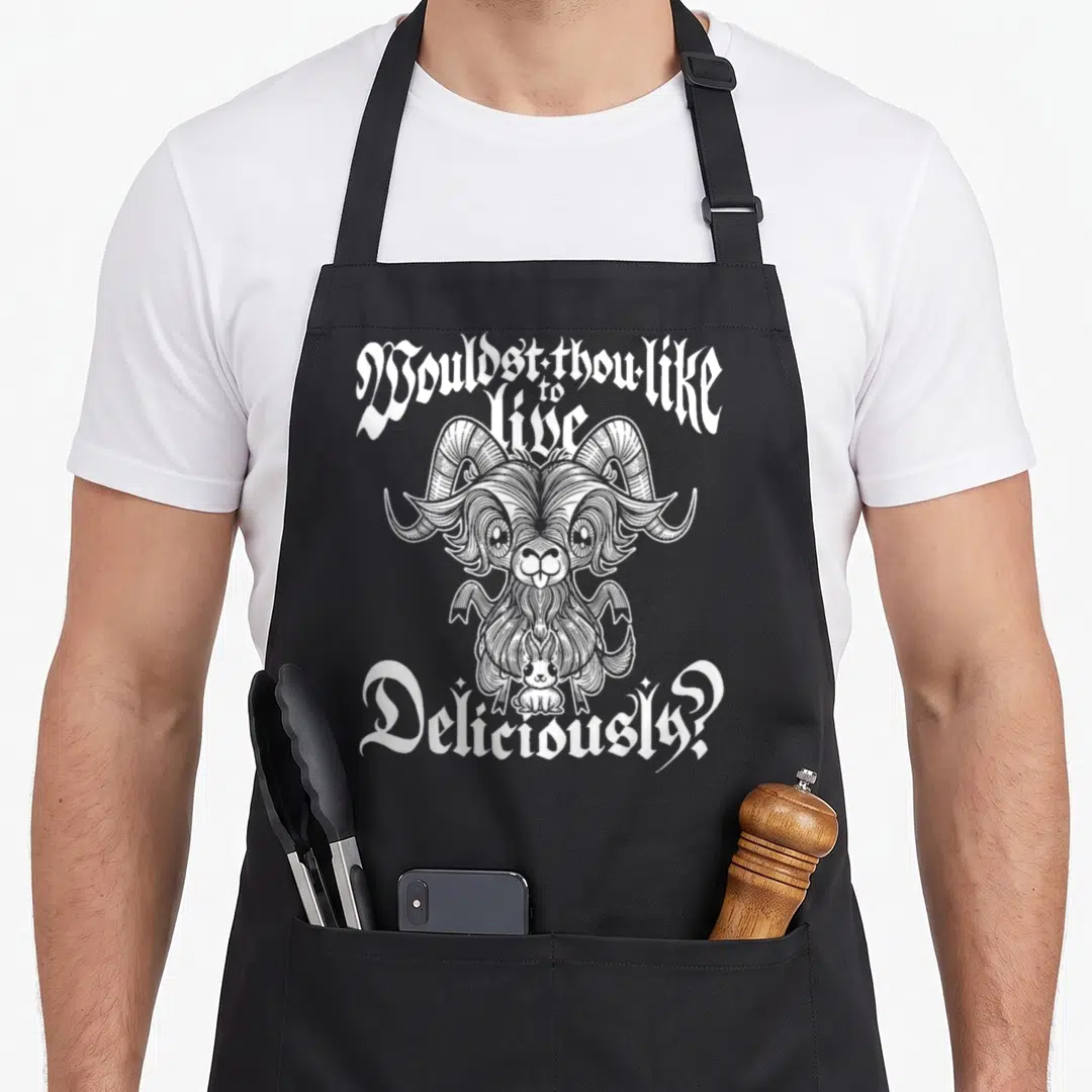 Satan goat apron - White line-art goat with rabbit and arched text Wouldst thou like to live Deliciously — shown on a black cotton canvas apron against a white background