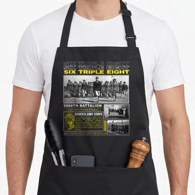 Triple tribute apron - SIX TRIPLE EIGHT text and 6888th Battalion photos with Women's Army Corps profile portrait — shown on a black cotton canvas apron against a white background
