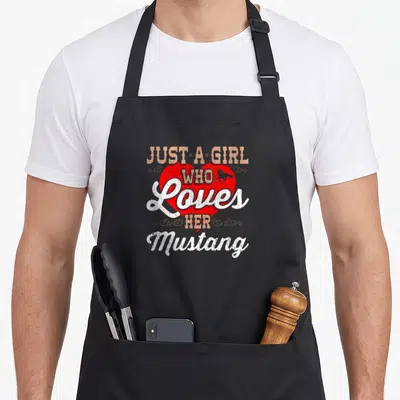 Funny mustang horse apron - Just A Girl Who Loves Her Mustang text with red heart and horse silhouette — shown on a black cotton canvas apron against a white background