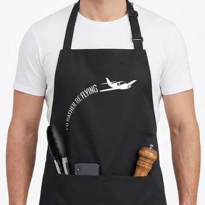 Rather airplane apron - White airplane silhouette with curved text I'D RATHER BE FLYING underneath — shown on a black cotton canvas apron against a white background