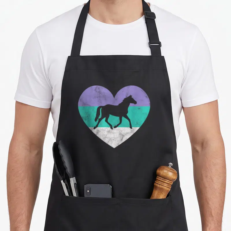 Funny horse apron - Grey horse silhouette inside a heart with purple teal and white horizontal stripes — shown on a black cotton canvas apron against a white background