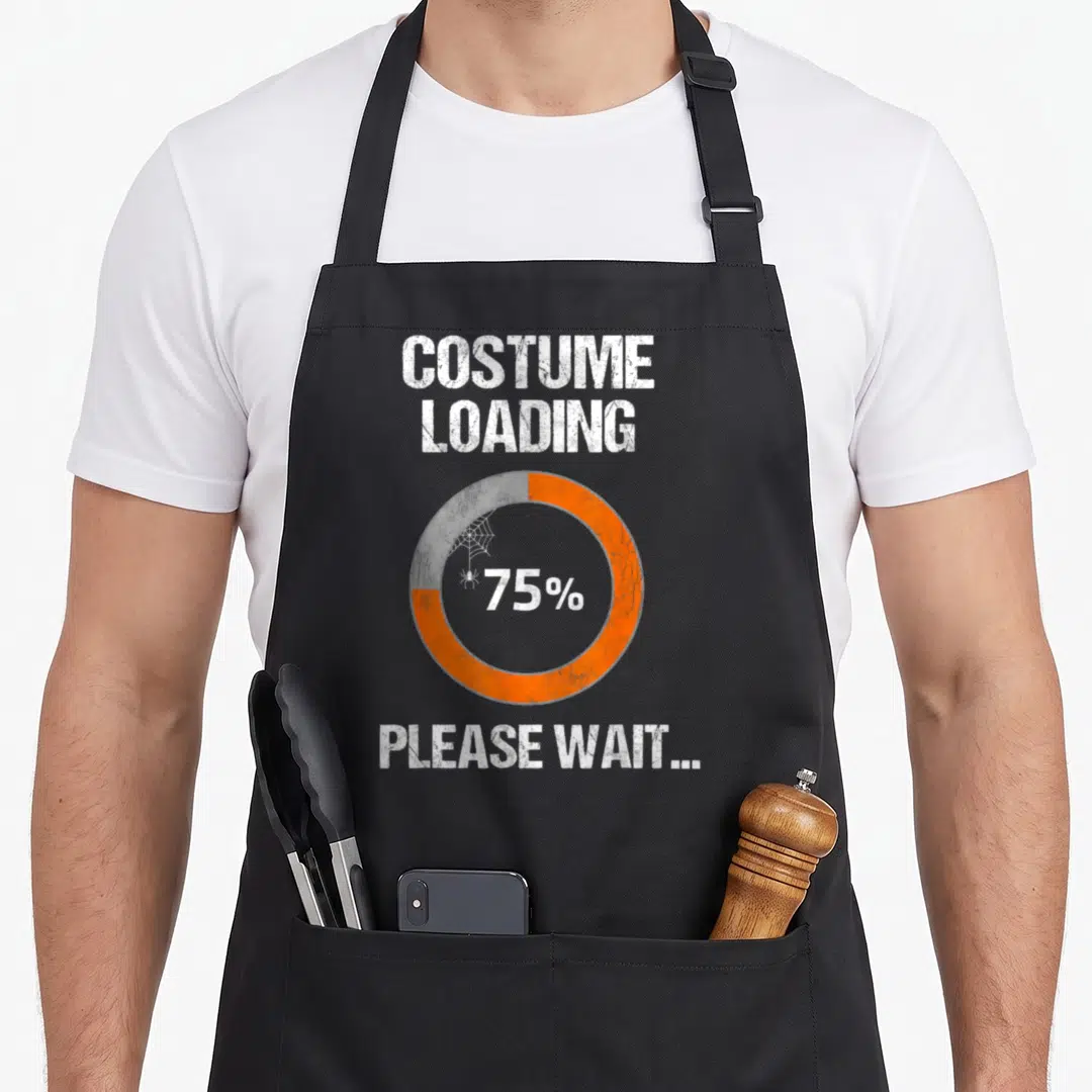 Costume geek aprons - Distressed white text Costume Loading 75% with orange grey circular bar and spider web graphic — shown on a black cotton canvas apron against a white background