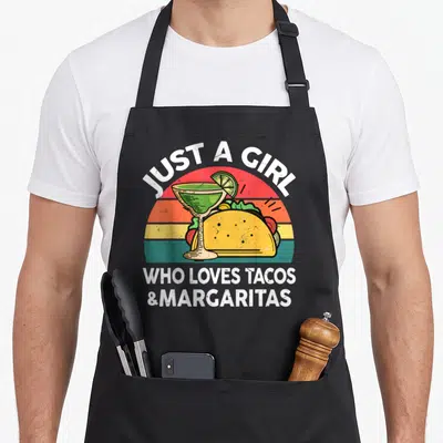 Taco margarita mexican apron - Retro striped sunset with taco and margarita glass under white text — shown on a black cotton canvas apron against a white background
