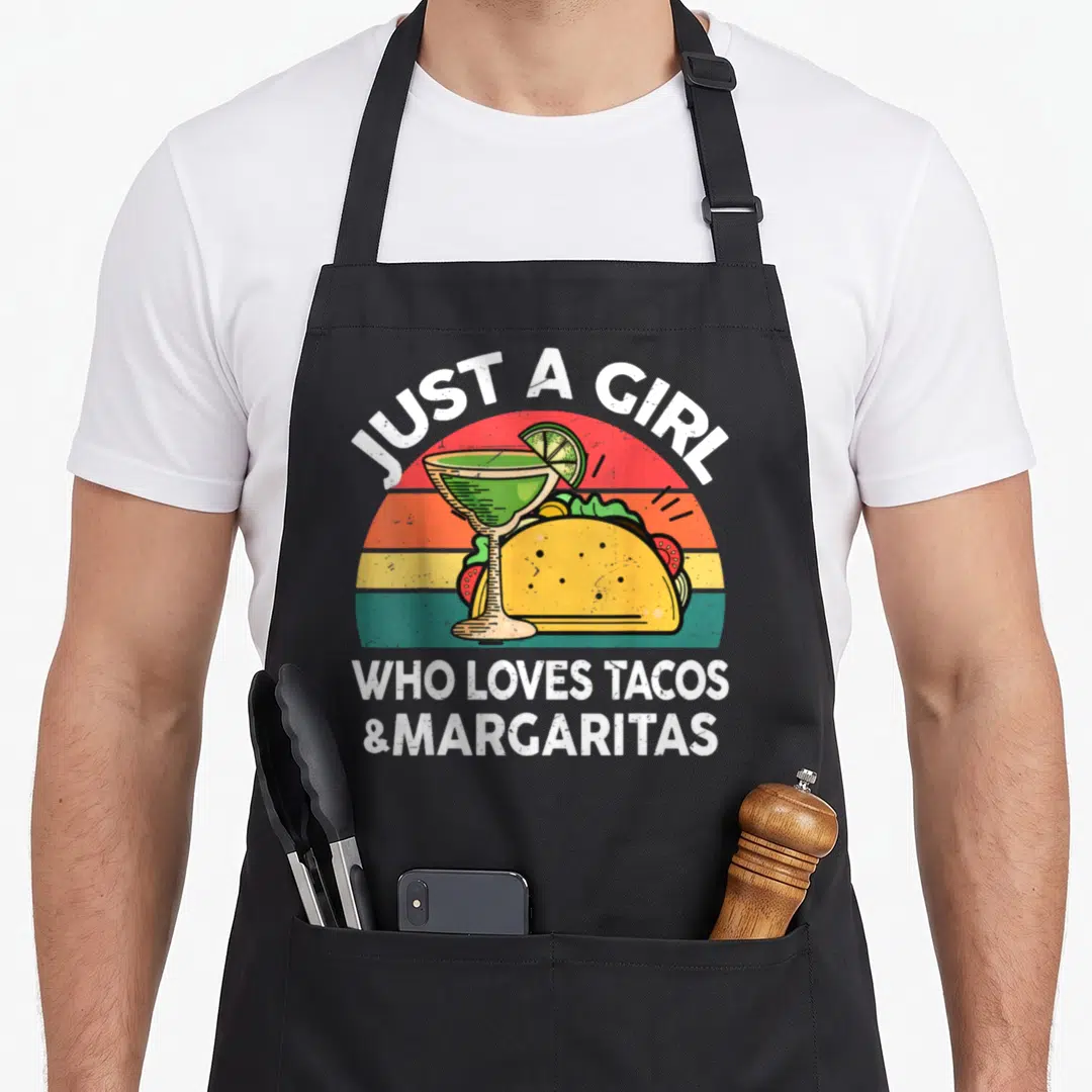 Taco margarita mexican apron - Retro striped sunset with taco and margarita glass under white text — shown on a black cotton canvas apron against a white background