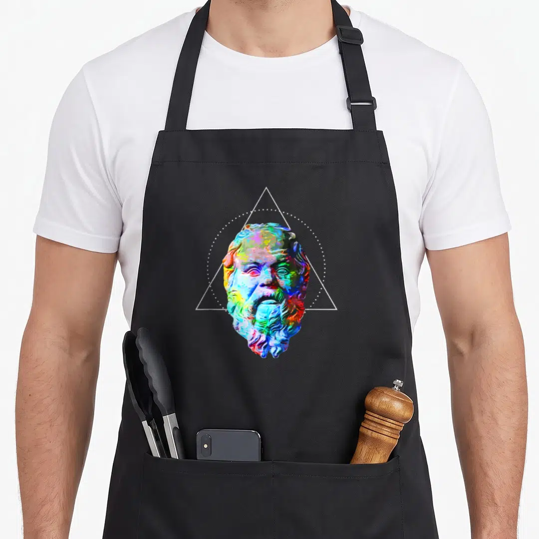 Socrate colorful aprons - Multicolored classical bust in white dotted circle and triangle frame — shown on a black cotton canvas apron against a white background