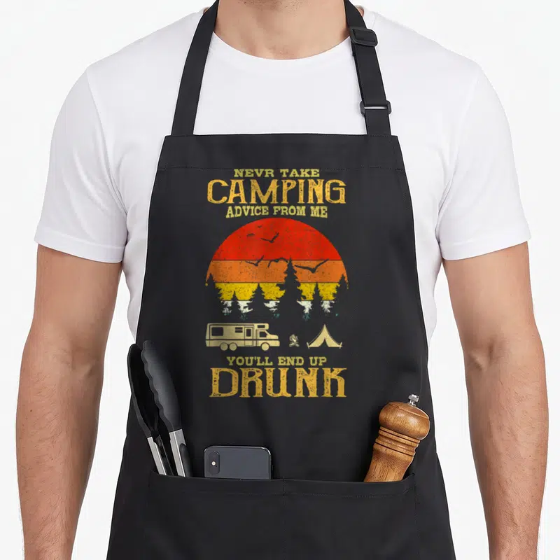 Drunk camping apron - Retro sun graphic with camper tent fire and text never take camping advice from me you'll end up — shown on a black cotton canvas apron against a white background