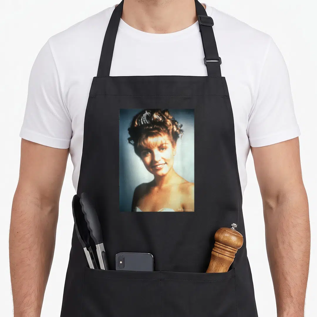 Palmer twin peaks apron - Photo of a woman in a tiara with beige white blue tones on black fabric — shown on a black cotton canvas apron against a white background