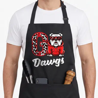 Bulldog georgia apron - Leopard G, bulldog in red hoodie, GAME DAY sunglasses, Dawgs script — shown on a black cotton canvas apron against a white background