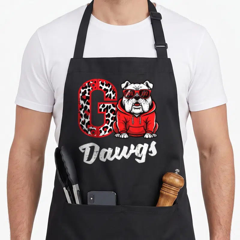 Bulldog georgia apron - Leopard G, bulldog in red hoodie, GAME DAY sunglasses, Dawgs script — shown on a black cotton canvas apron against a white background
