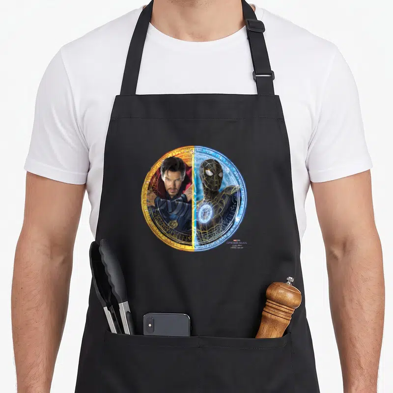 Way split apron - Two characters split vertically in a circular portal with orange and blue sides — shown on a black cotton canvas apron against a white background