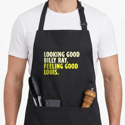 Ray billy apron - Yellow stacked text reading Looking Good Billy Ray Feeling Good Louis — shown on a black cotton canvas apron against a white background