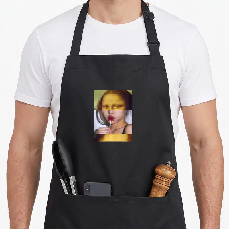 Artcollage lollipop apron - Composite portrait with gold painted face sections and central photo of woman holding red — shown on a black cotton canvas apron against a white background