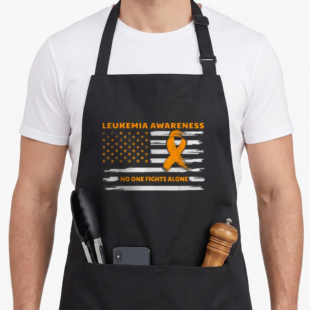 Cancer leukemia awareness apron - Orange ribbon over distressed white stripes and stars with awareness text — shown on a black cotton canvas apron against a white background