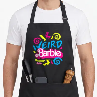 Funny weird aprons - WEIRD Barbie text in blue and white on a pink blob with colorful swirls and zigzags — shown on a black cotton canvas apron against a white background