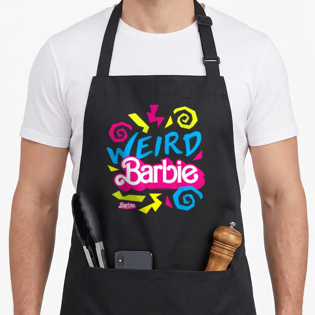 Funny weird aprons - WEIRD Barbie text in blue and white on a pink blob with colorful swirls and zigzags — shown on a black cotton canvas apron against a white background