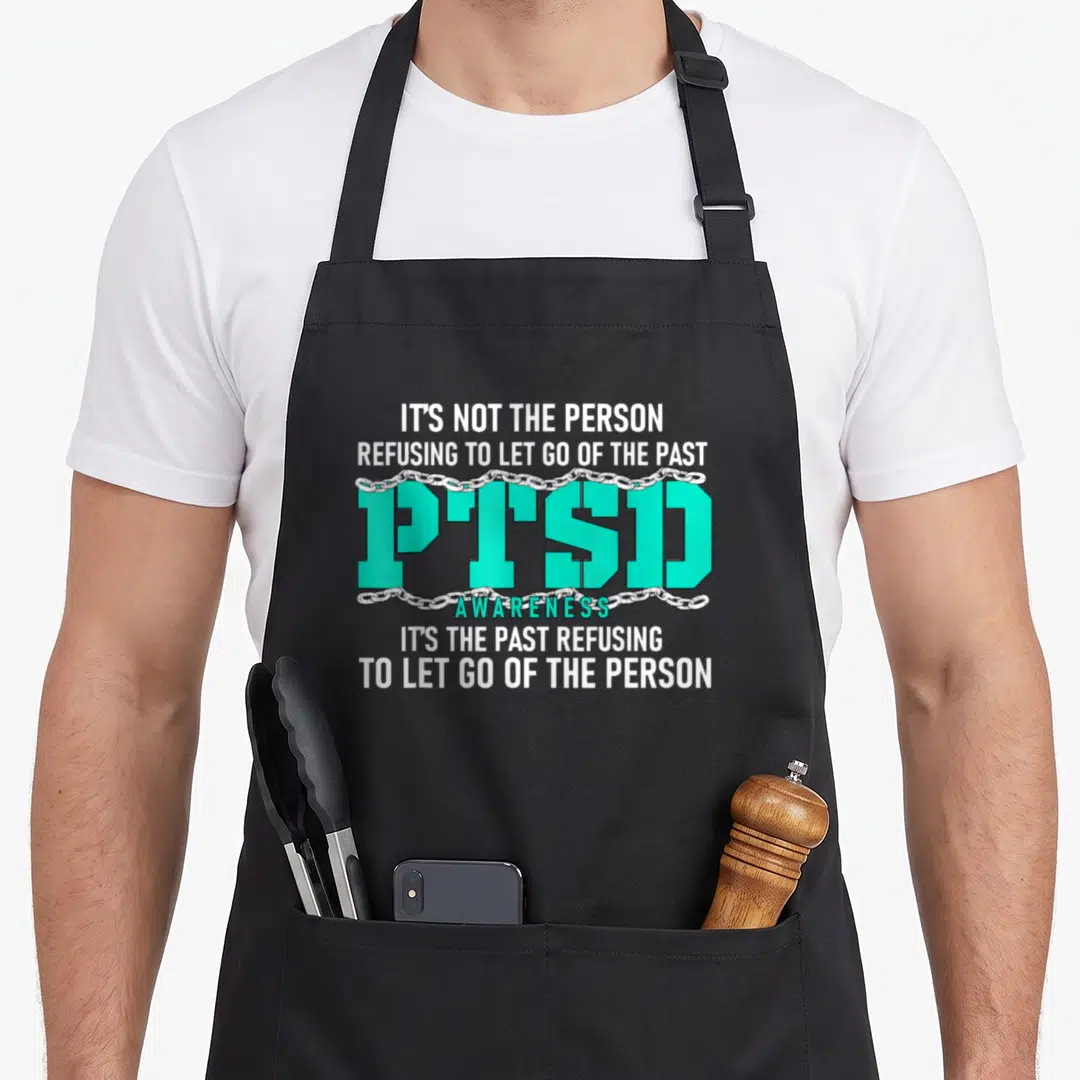 Ptsd ribbon apron - Teal PTSD text with silver chains and white awareness quote — shown on a black cotton canvas apron against a white background