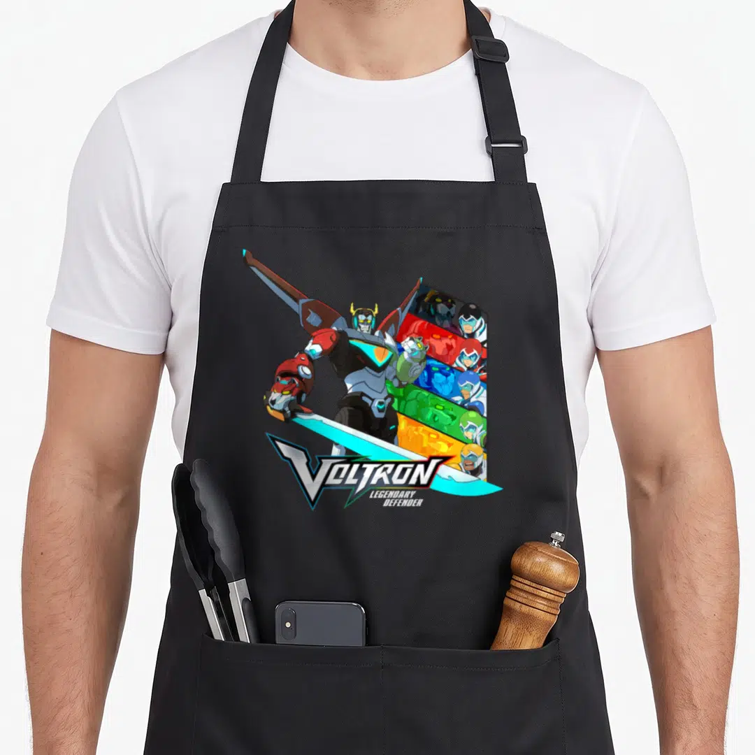 Legendary defender apron - Voltron robot holding sword with five pilots in red blue yellow green black panels — shown on a black cotton canvas apron against a white background