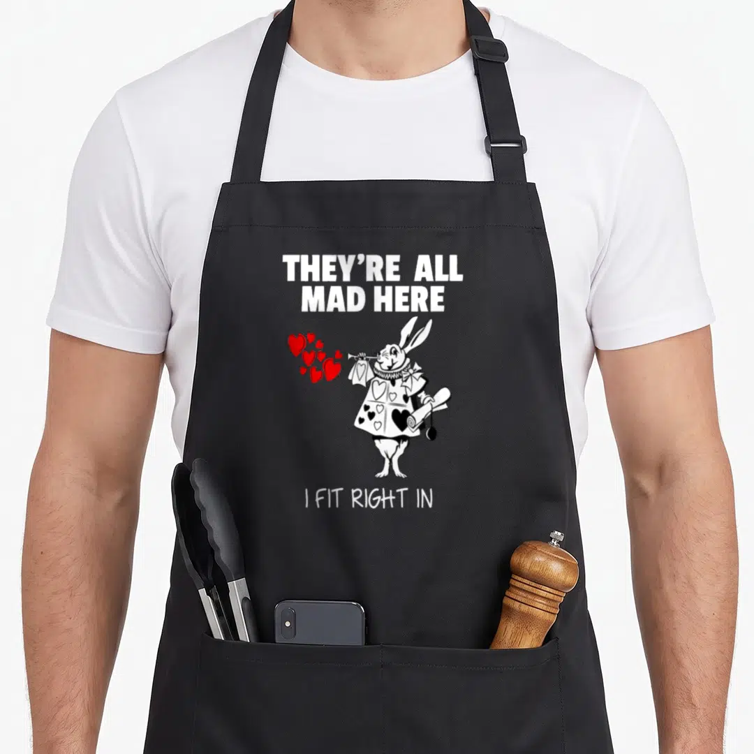 Cute alice rabbit apron - White rabbit blowing red hearts with mad quote on black apron — shown on a black cotton canvas apron against a white background