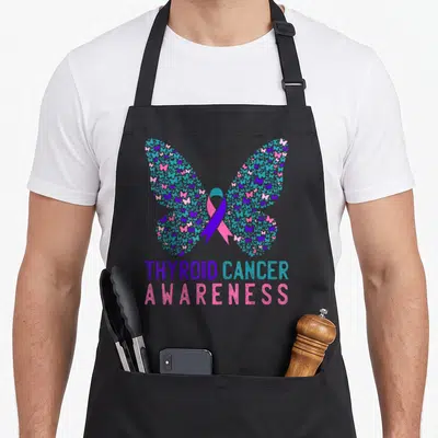 Butterfly thyroid apron - Large butterfly formed by small blue pink and purple butterflies with central ribbon — shown on a black cotton canvas apron against a white background