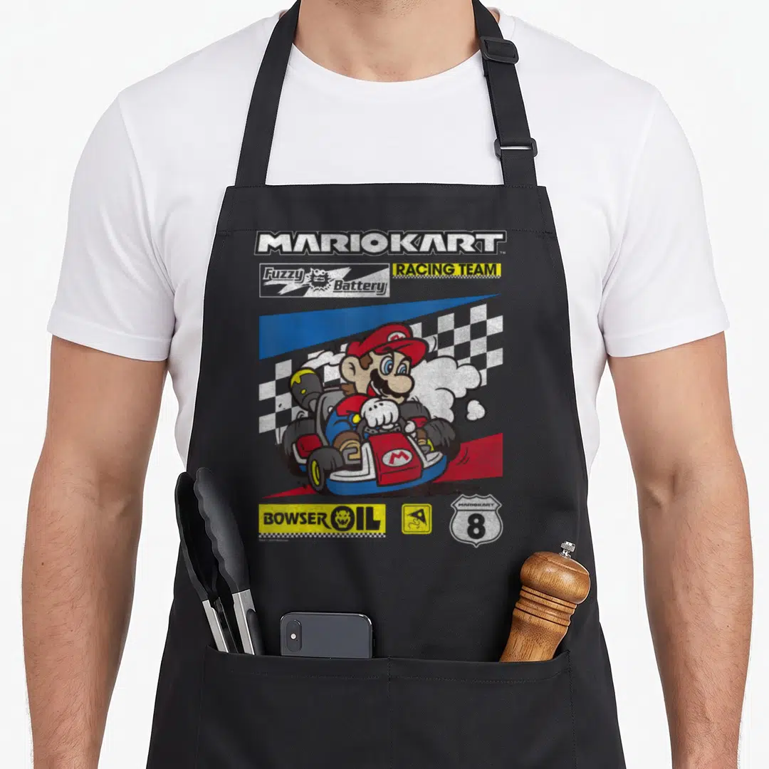 Drifting racing apron - Mario driving a red kart with MARIOKART and BOWSER OIL sponsor logos on a checkered background — shown on a black cotton canvas apron against a white background