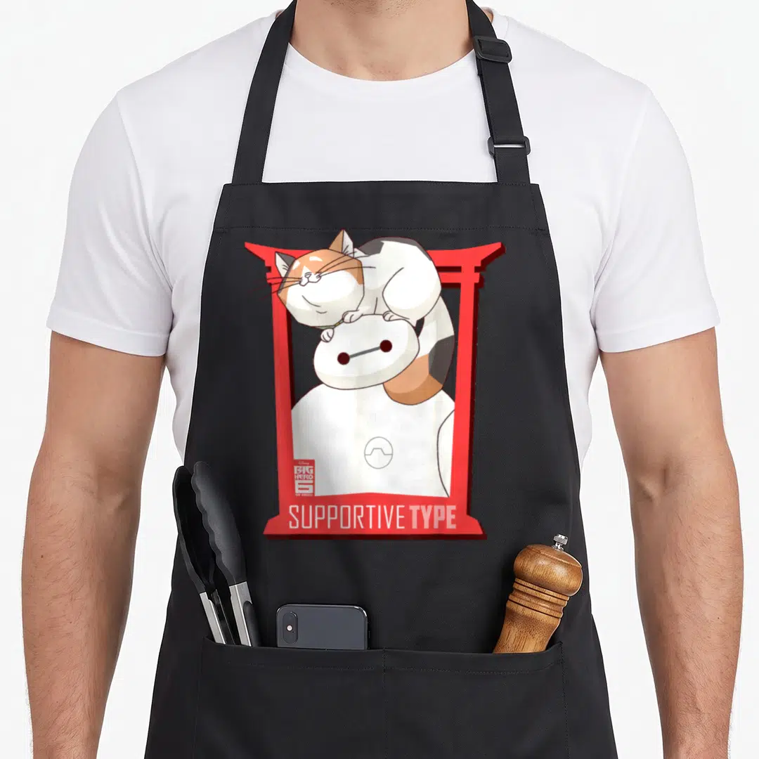 Baymax cat apron - Baymax in red torii gate with calico cat on head and SUPPORTIVE TYPE text — shown on a black cotton canvas apron against a white background