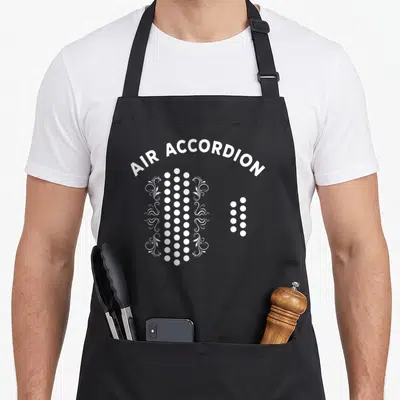 Musical accordion apron - Arched AIR ACCORDION text above white dots and floral swirls — shown on a black cotton canvas apron against a white background