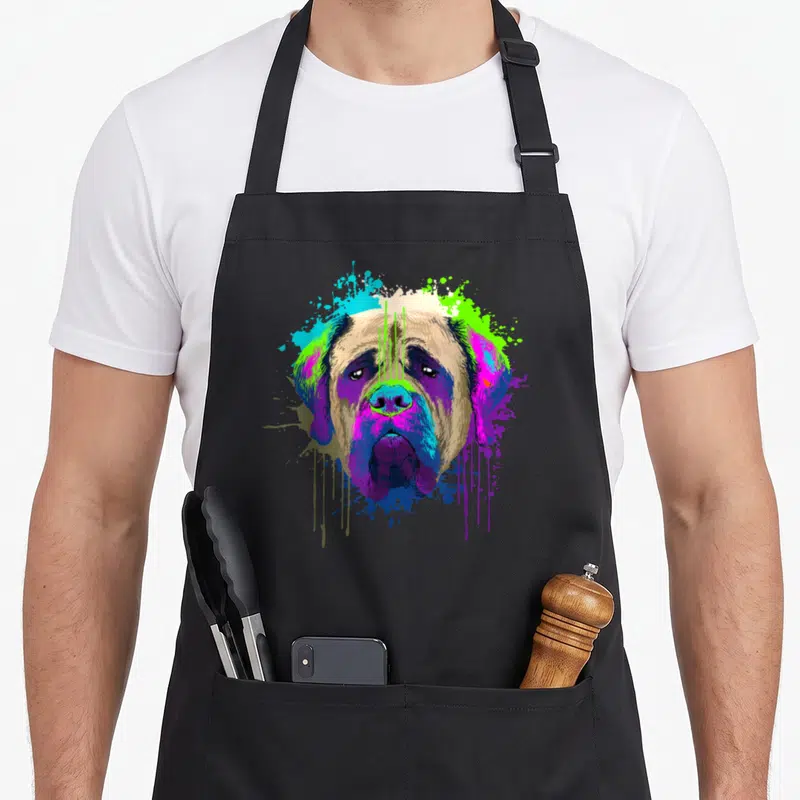 Holder dog apron - Cartoon mastiff head with purple blue green and tan paint splatters — shown on a black cotton canvas apron against a white background