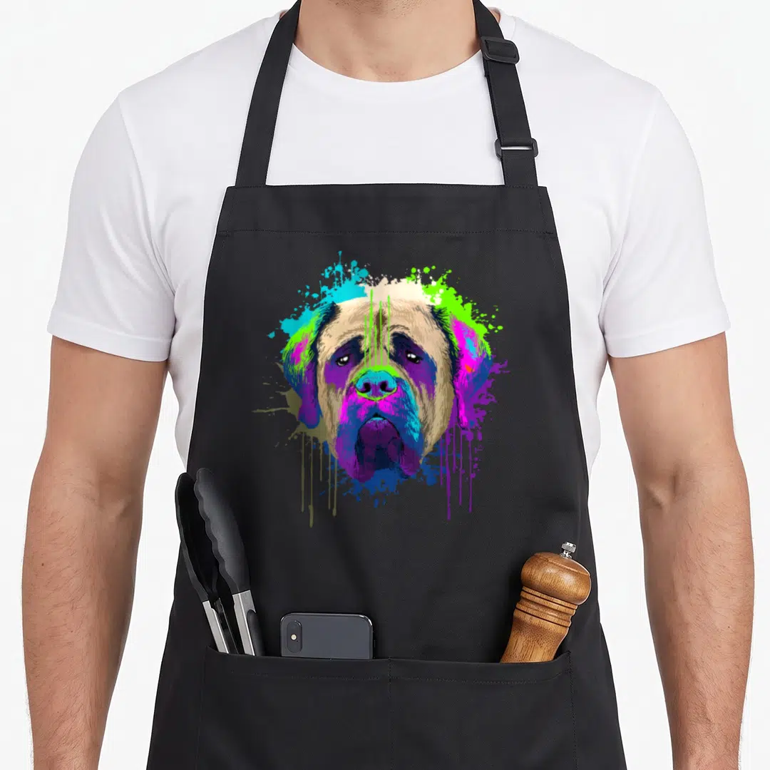 Holder dog apron - Cartoon mastiff head with purple blue green and tan paint splatters — shown on a black cotton canvas apron against a white background