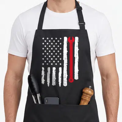 Wrench auto mechanic apron - Red wrench replacing a stripe in a distressed white and grey flag pattern — shown on a black cotton canvas apron against a white background