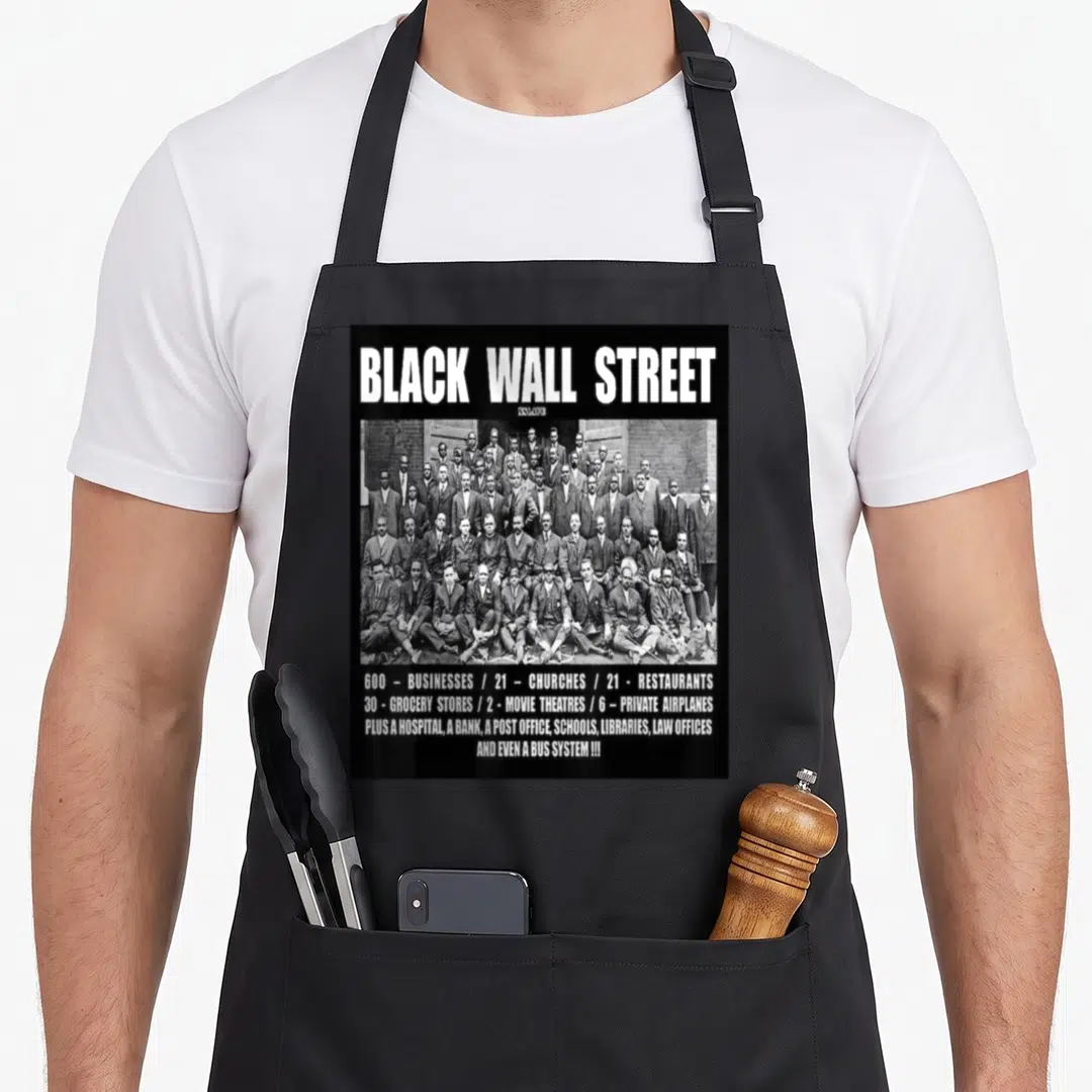 Wall street workout apron - Black Wall Street text above grayscale men in suits and four lines of business statistics — shown on a black cotton canvas apron against a white background