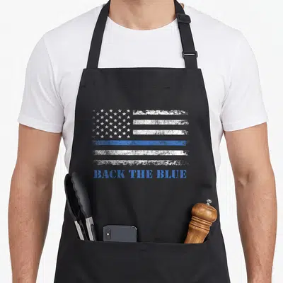 Thin american flag apron - Distressed white and blue flag with BACK THE BLUE text on black apron — shown on a black cotton canvas apron against a white background