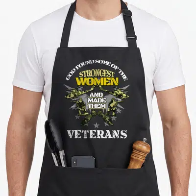 Gott patriots apron - Text reading God Found Some of the Strongest Women and Made Them Veterans with helicopters — shown on a black cotton canvas apron against a white background