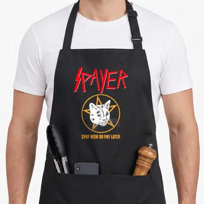Spayer cat apron - Red spayer text over white cat head in orange pentagram with bottom slogan — shown on a black cotton canvas apron against a white background
